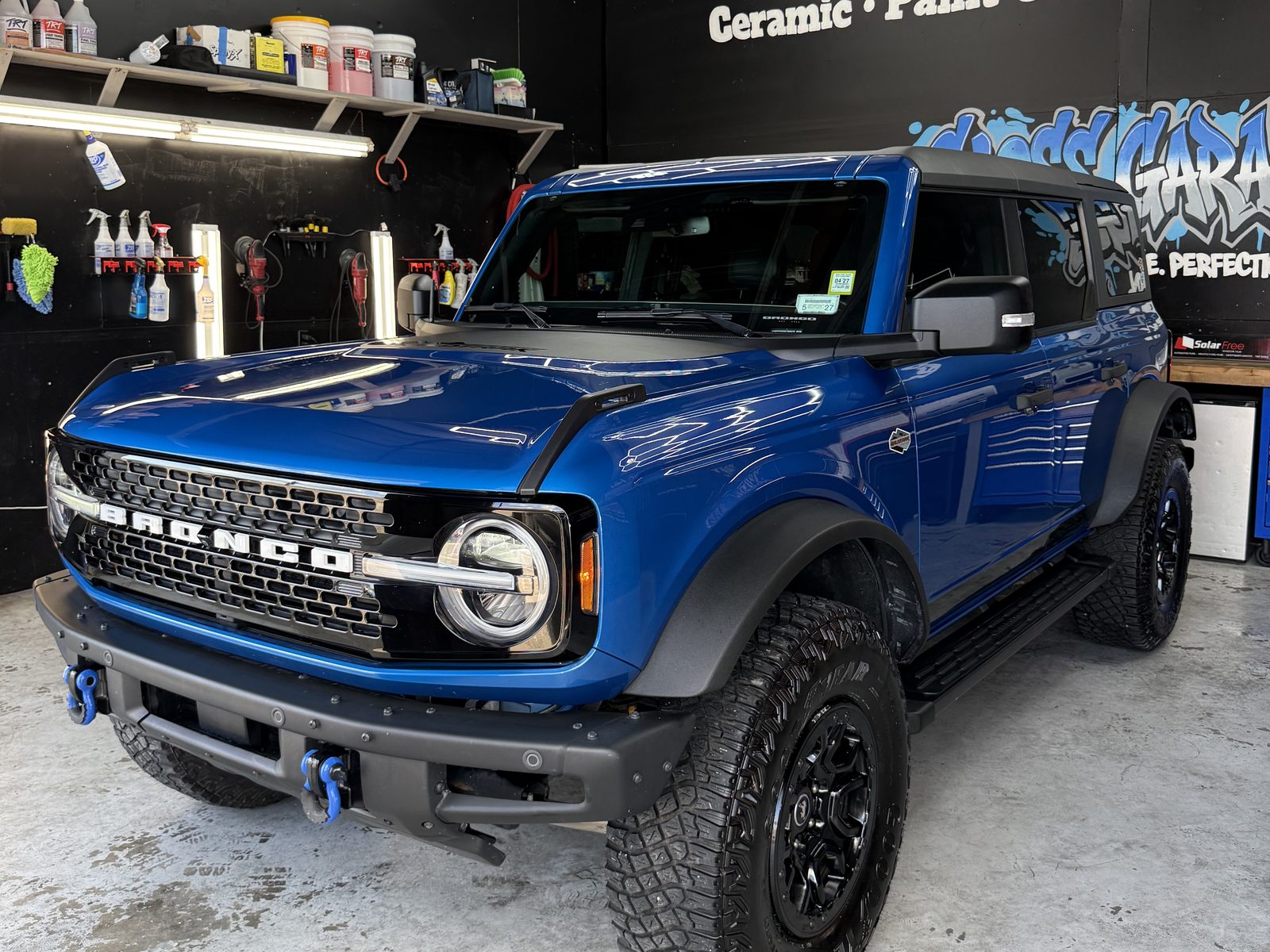 Blue Ford Bronco finished under the hexagon lights in the Gloss Garage shop in Venice, FL