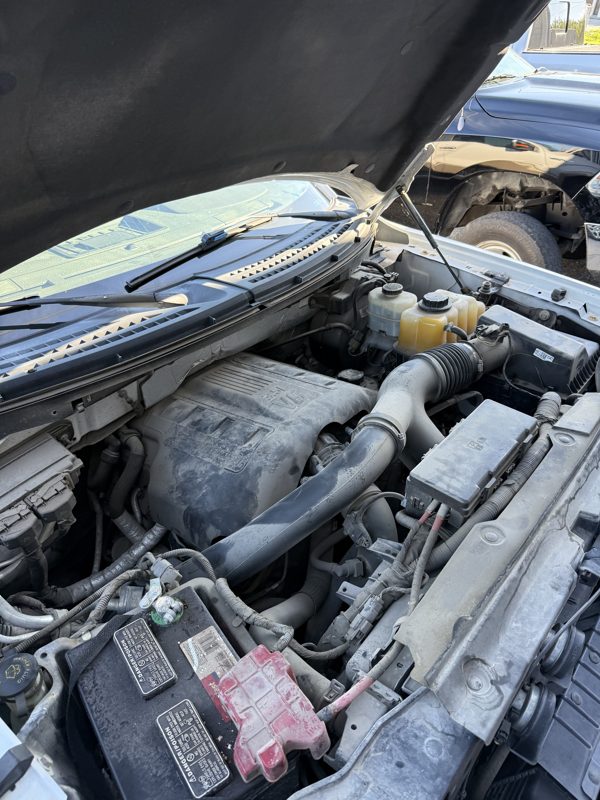 Dusty Ford truck engine bay before cleaning
