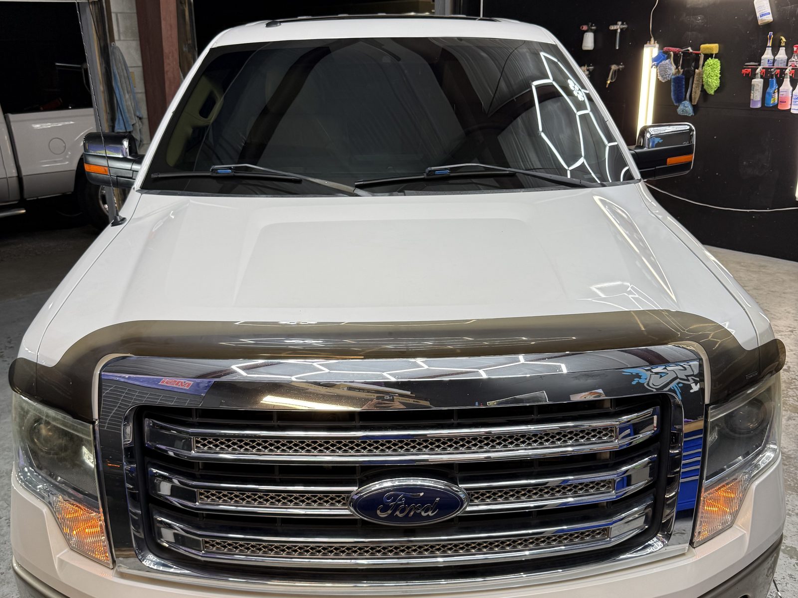 F-150 head-on with hex lights reflected in the windshield