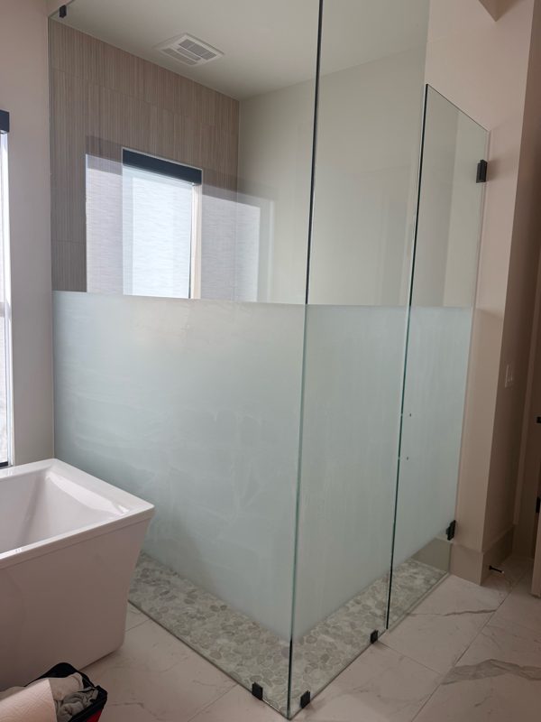 The same shower enclosure with frosted film on the lower panels