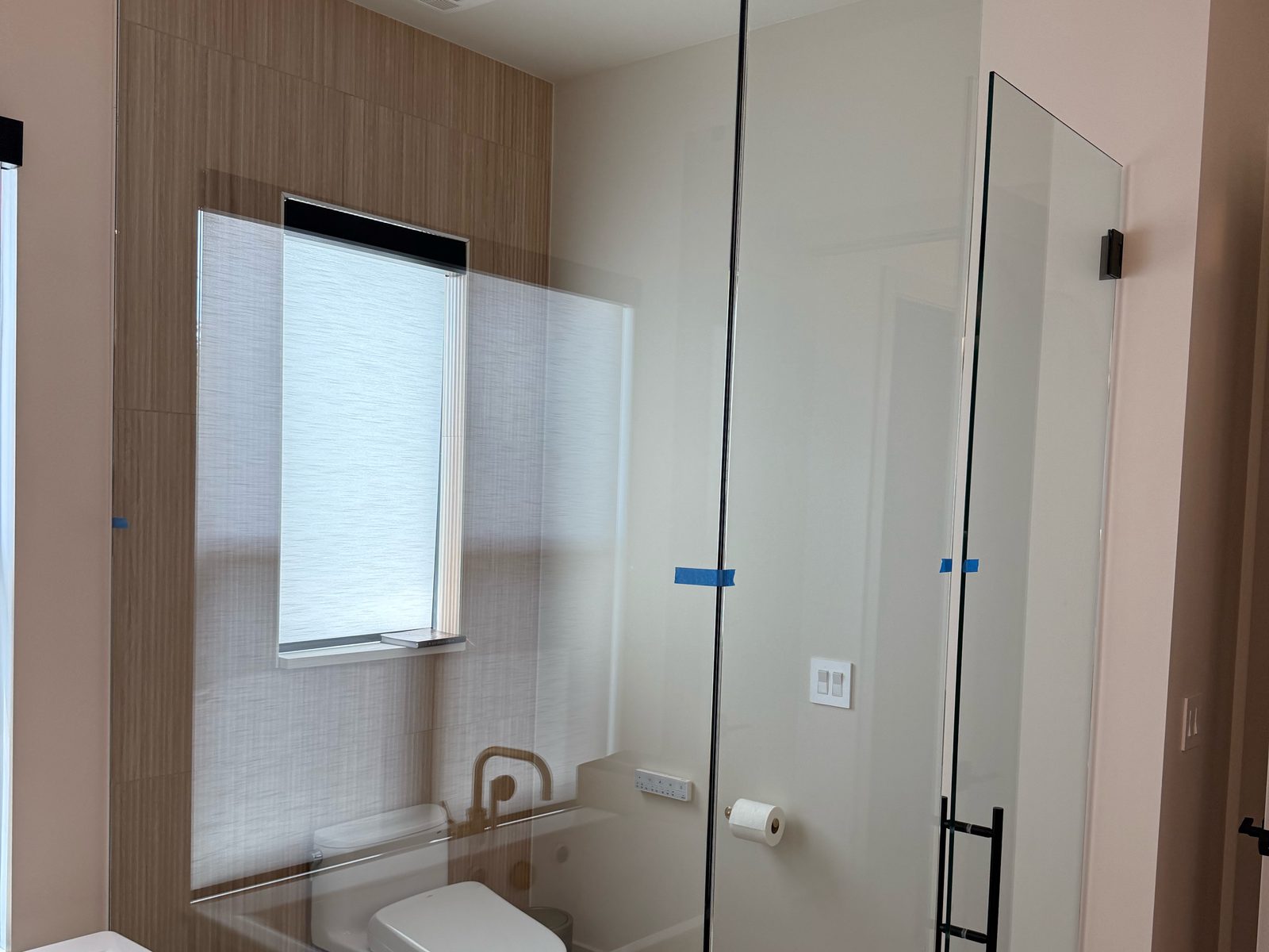 Clear shower glass before privacy film