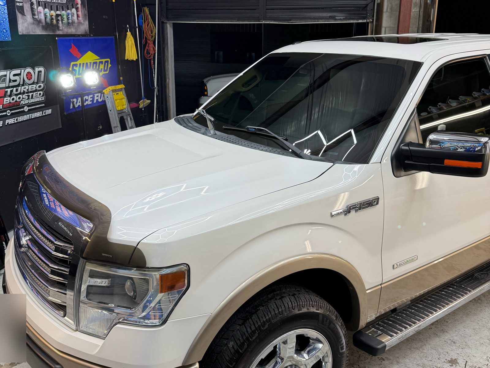 White Ford F-150 with new window tint in the Gloss Garage bay