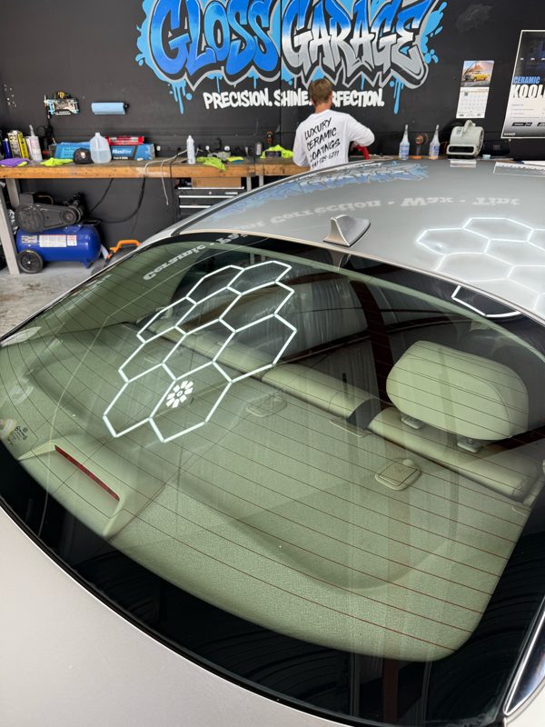Rear-window film being installed on a sedan in the bay