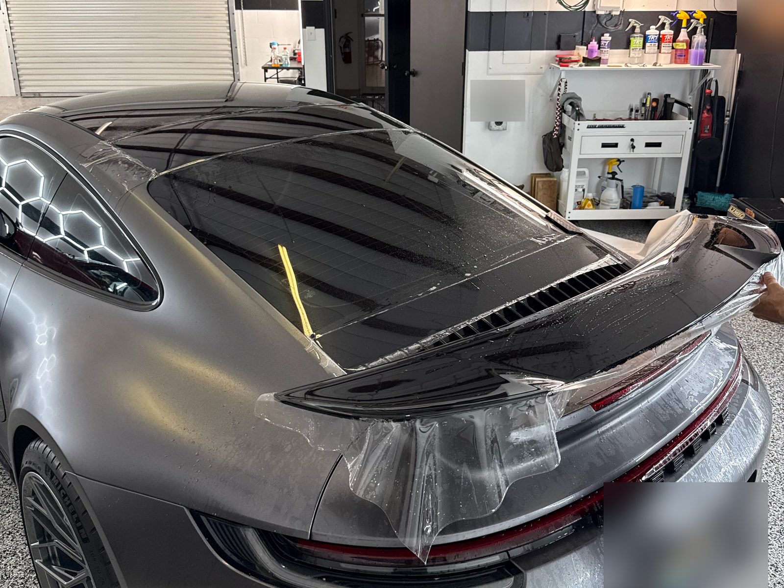 PPF being installed on the 911 rear spoiler